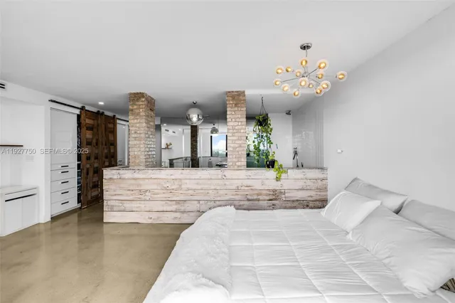 a bedroom with a large bed and a white bath tub