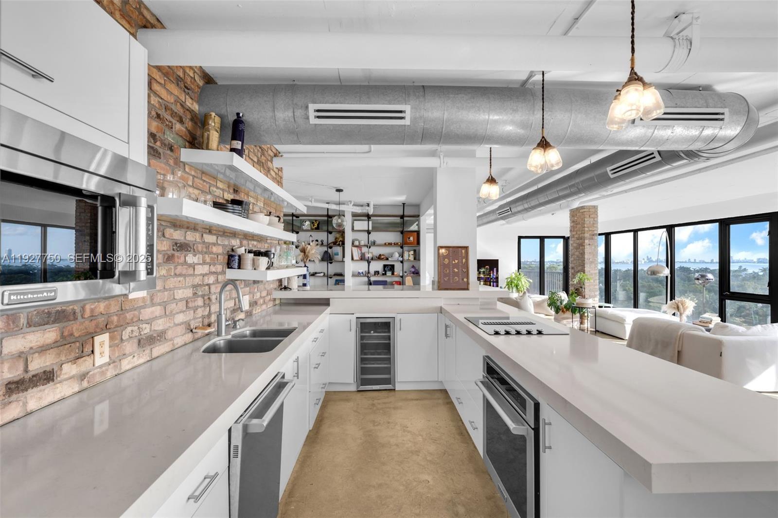 5701 Biscayne Boulevard, Unit PH9 Miami, FL 33137 - Photo 3 of 40 a large white kitchen with a large window