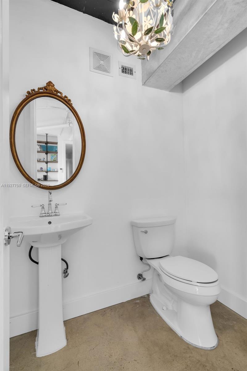 5701 Biscayne Boulevard, Unit PH9 Miami, FL 33137 - Photo 32 of 40 a bathroom with a sink mirror and vanity