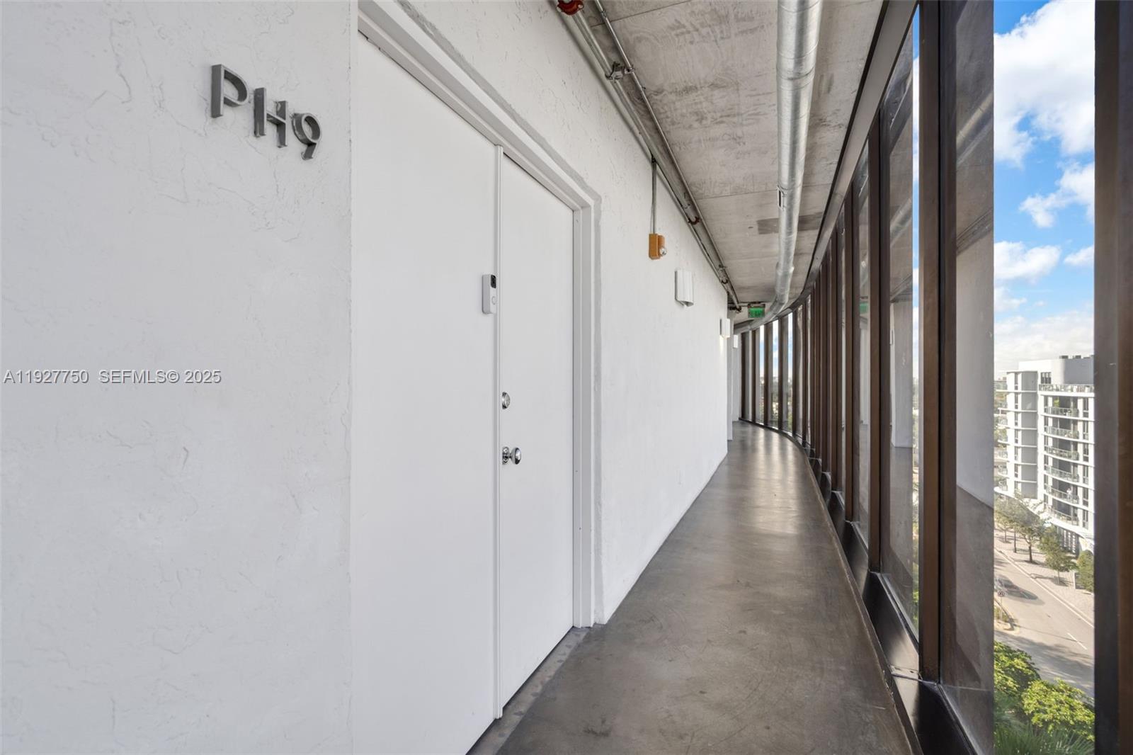 5701 Biscayne Boulevard, Unit PH9 Miami, FL 33137 - Photo 34 of 40 a view of a hallway with wooden floor and door