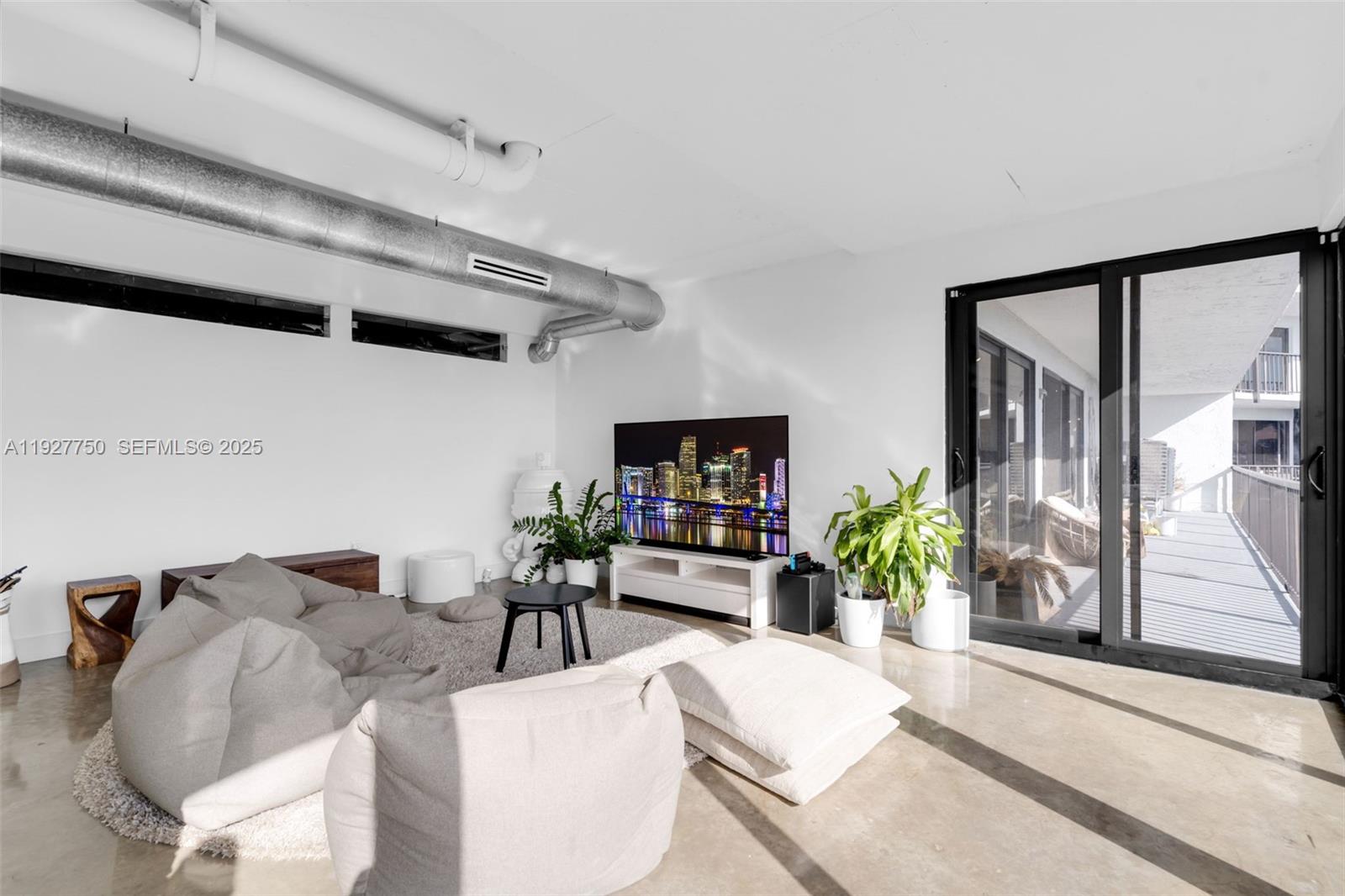 5701 Biscayne Boulevard, Unit PH9 Miami, FL 33137 - Photo 6 of 40 a living room with furniture potted plant and a large window