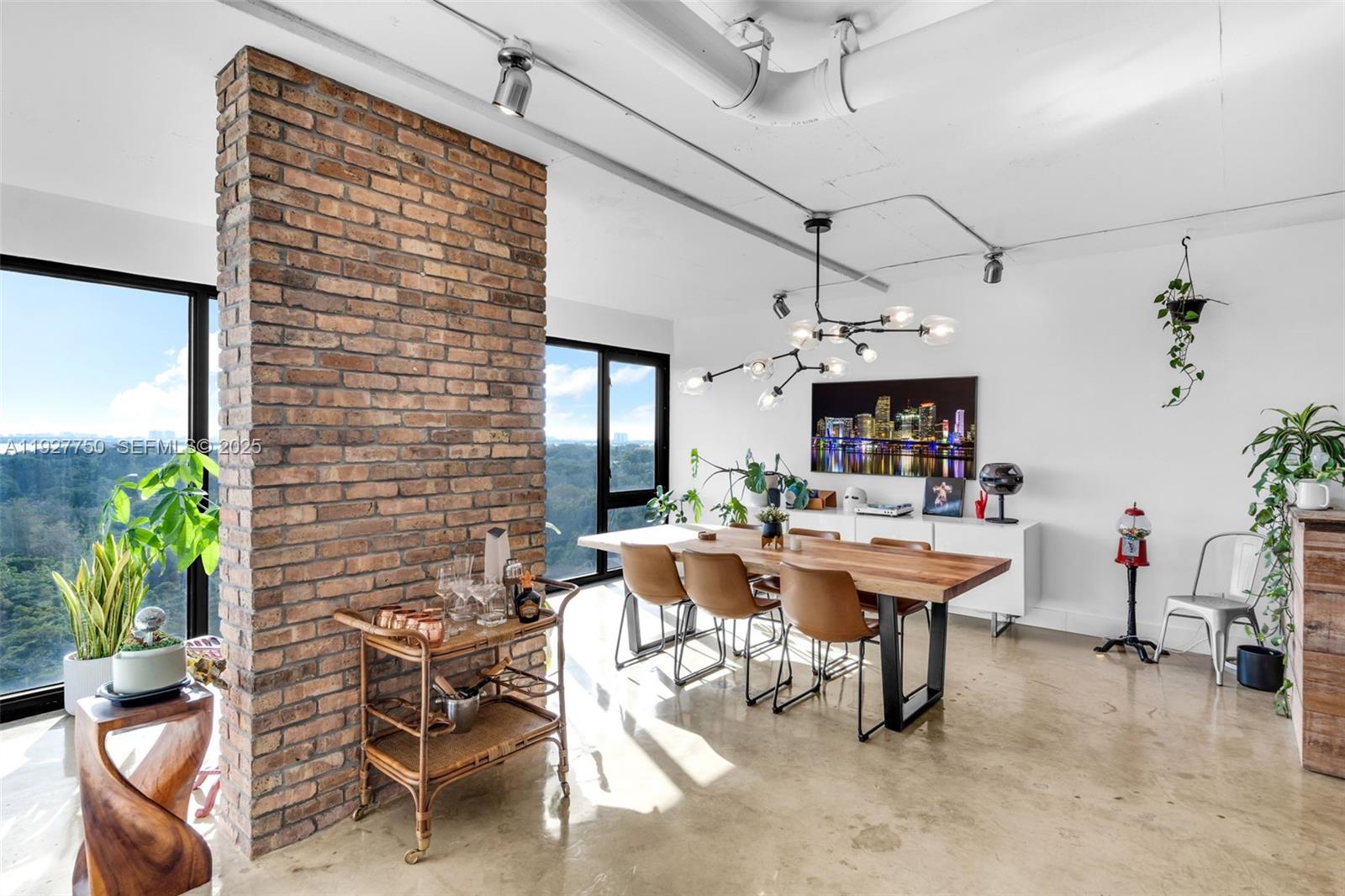 5701 Biscayne Boulevard, Unit PH9 Miami, FL 33137 - Photo 10 of 40 a view of a patio with dining table and chairs