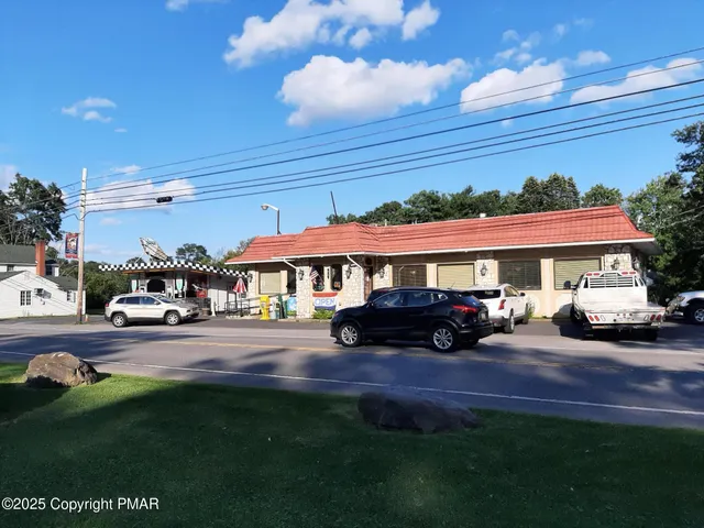 a view of a house with backyard porch and sitting area