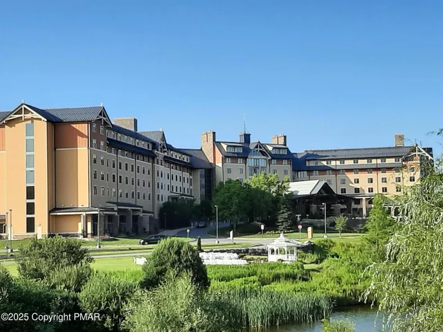 a view of a house with a yard and potted plants