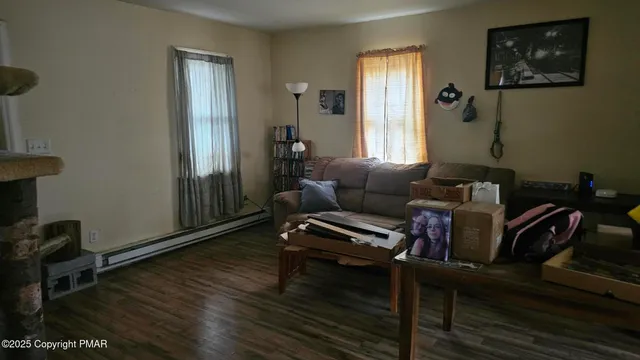 a living room with furniture a rug and a window