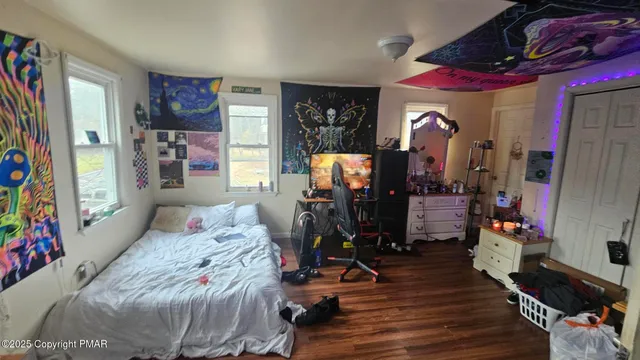 a bedroom with furniture and a flat screen tv