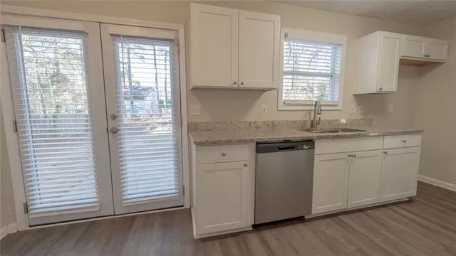 an empty room with windows and closet