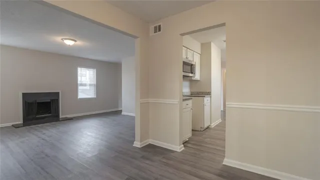 a view of a hallway with wooden floor