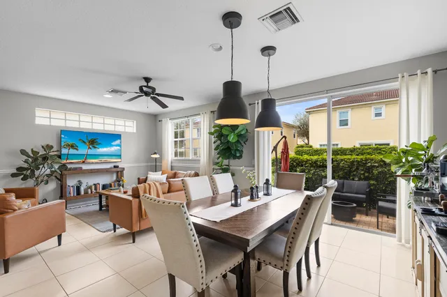 a dining room with furniture window and wooden floor