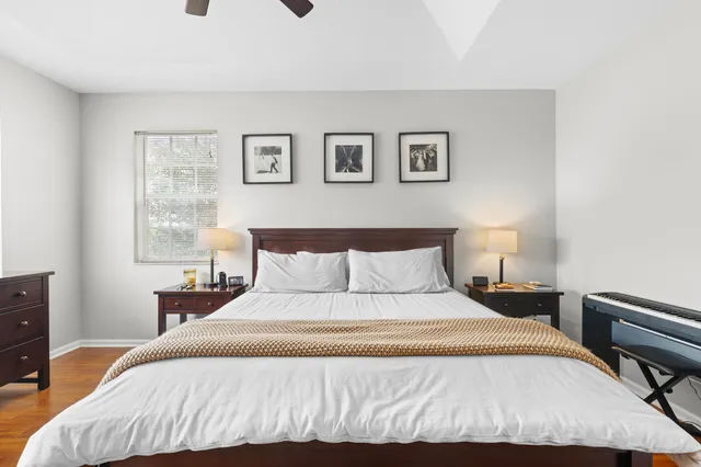 a bedroom with a bed and a lamp on dresser