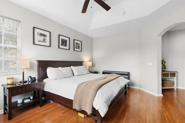 a bedroom with a bed and wooden floor