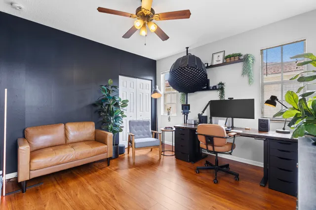 a living room with furniture and a wooden floor