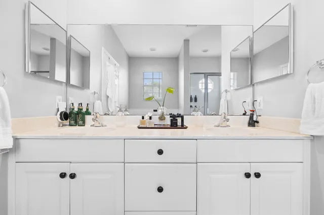 a bathroom with a sink vanity and mirror