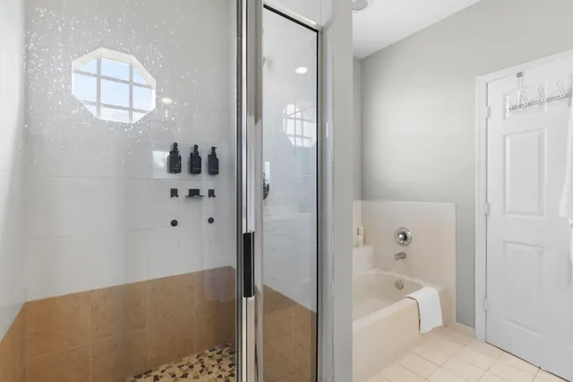 a bathroom with a bathtub and shower