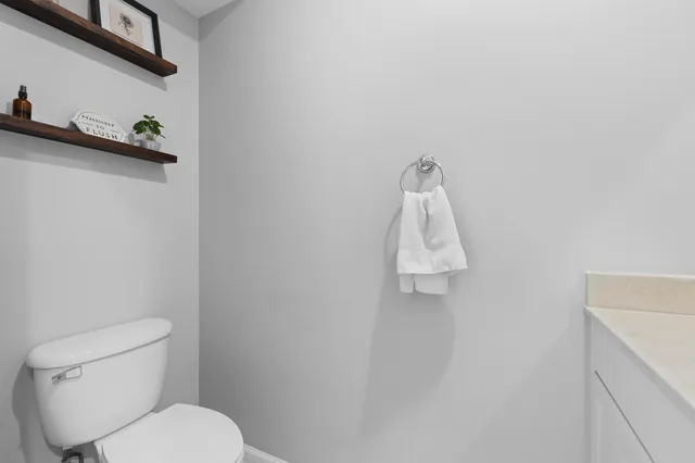 a white toilet sitting next to a white sink