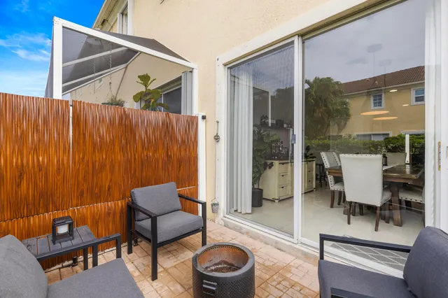 a balcony with furniture and a potted plant