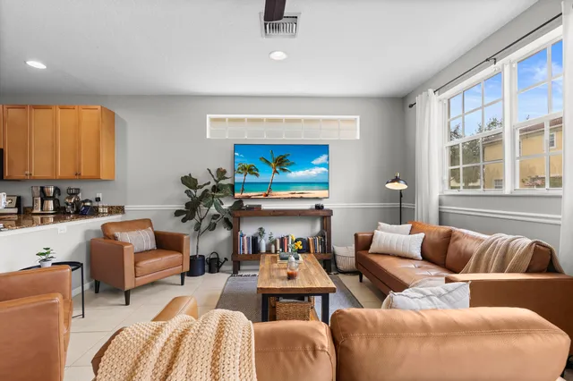 a living room with furniture a window and a flat screen tv
