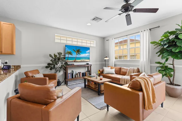 a living room with furniture and a potted plant