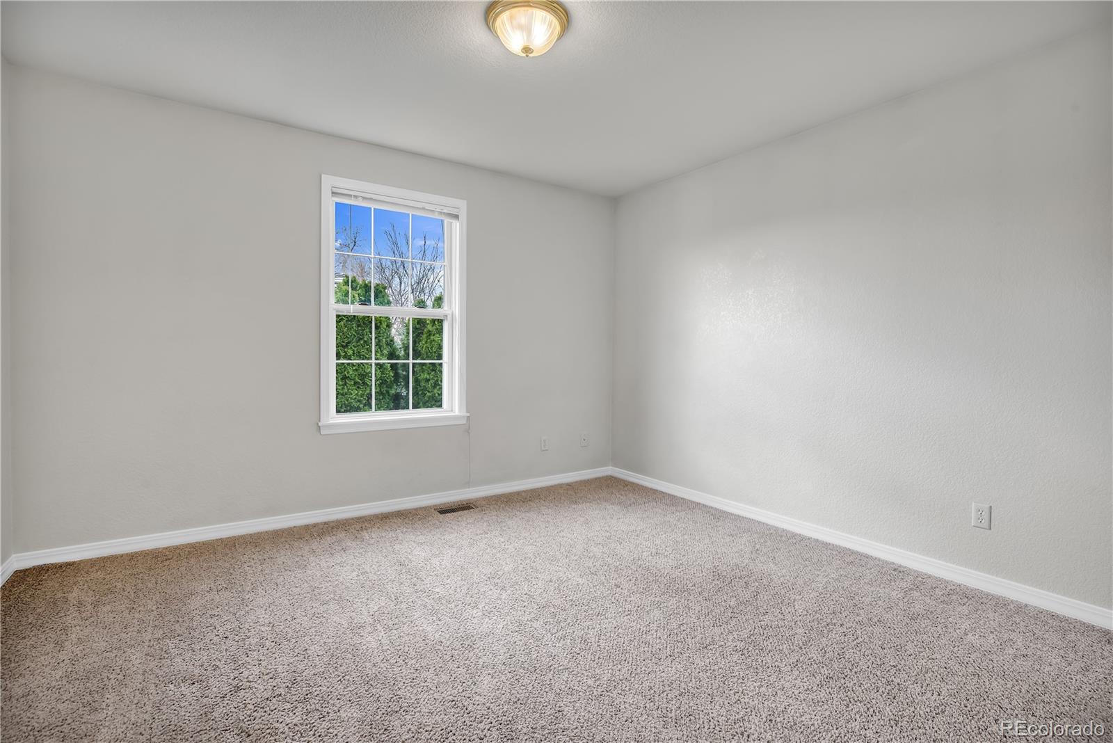 11690 West 46th Avenue Wheat Ridge, CO 80033 - Photo 18 of 33 a view of an empty room with a window