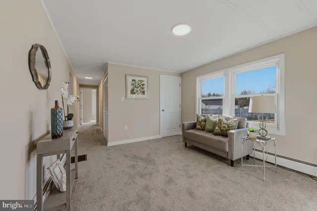 a living room with furniture and a mirror