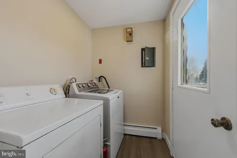 a view of a storage and utility room with a washer dryer