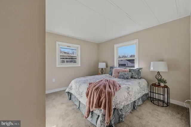 a bedroom with a bed and a night stand