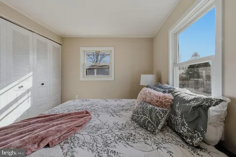 a bedroom with a large bed and a window