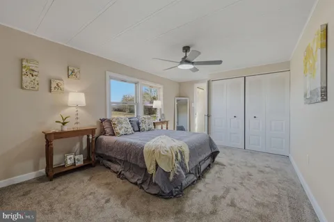 a spacious bedroom with a bed and a chandelier