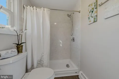 a bathroom with a shower curtain and a toilet