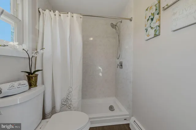 a bathroom with a shower curtain and a toilet