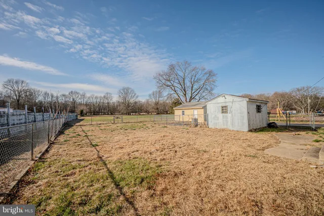 a view of a white house with a yard
