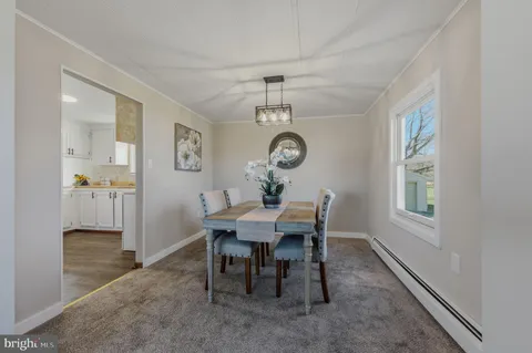 a view of a dining room with a table and chairs