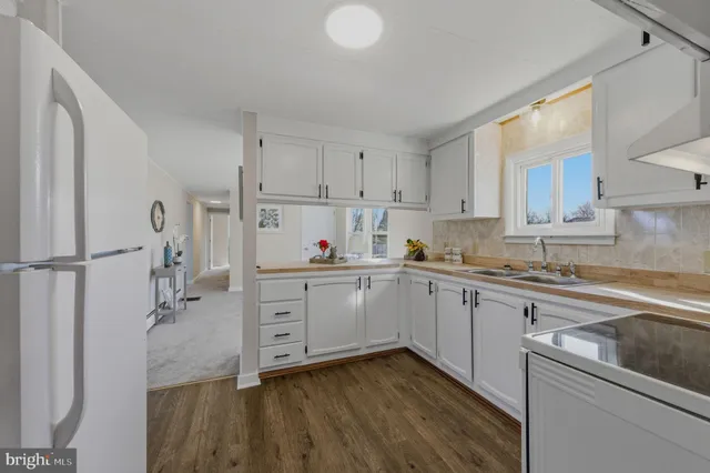 a kitchen with cabinets appliances and a window