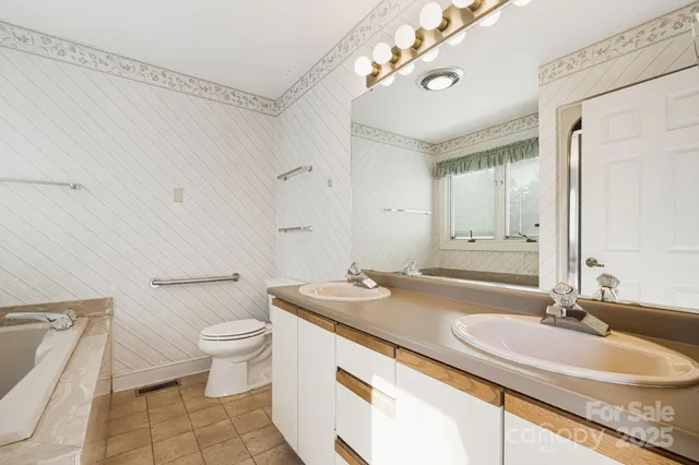 a bathroom with a bathtub and a window