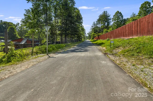 a view of a street with a yard