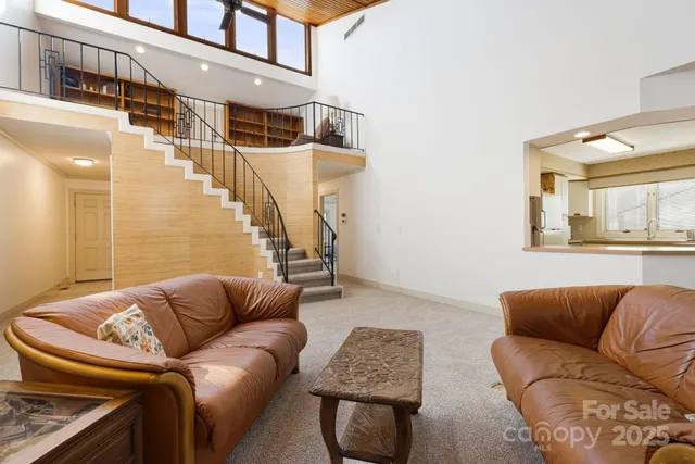 a living room with furniture and a painting