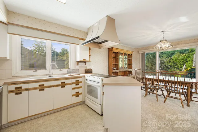 a utility room with cabinets washer and dryer