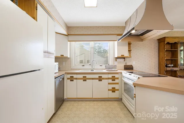 a kitchen with stainless steel appliances a refrigerator and a sink