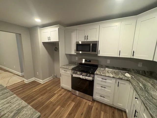 a kitchen with a stove a sink and a refrigerator