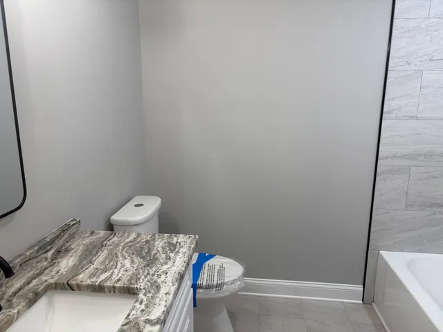 a view of hallway with window and wooden floor
