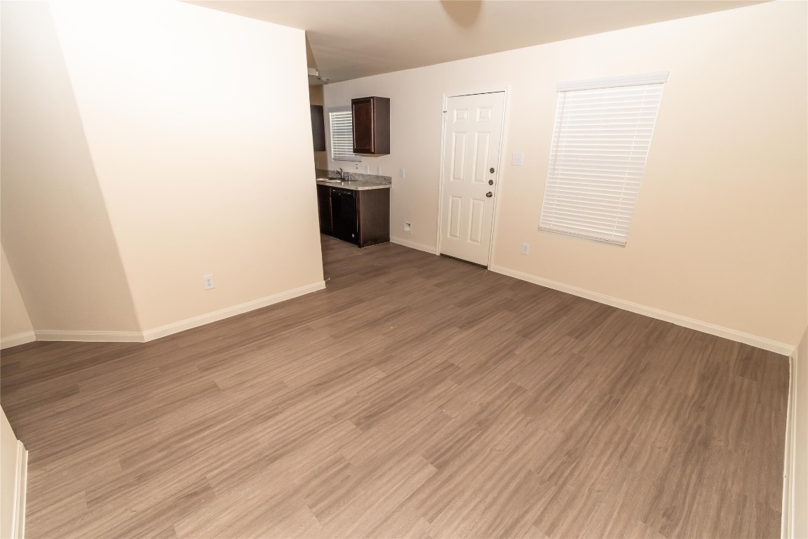 4259 Silver Ranch Road Houston, TX 77014 - Photo 5 of 9 a view of a kitchen from the hallway with wooden floor