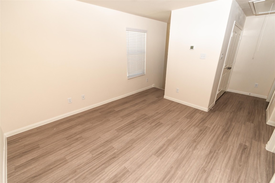 4259 Silver Ranch Road Houston, TX 77014 - Photo 7 of 9 an empty room with wooden floor