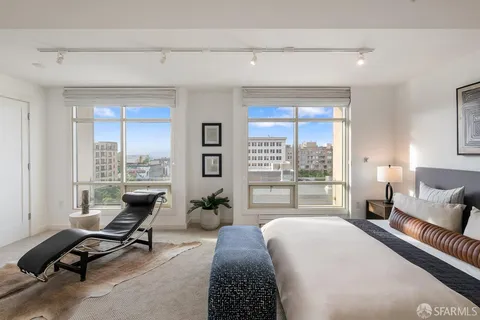 a bedroom with a bed and large window