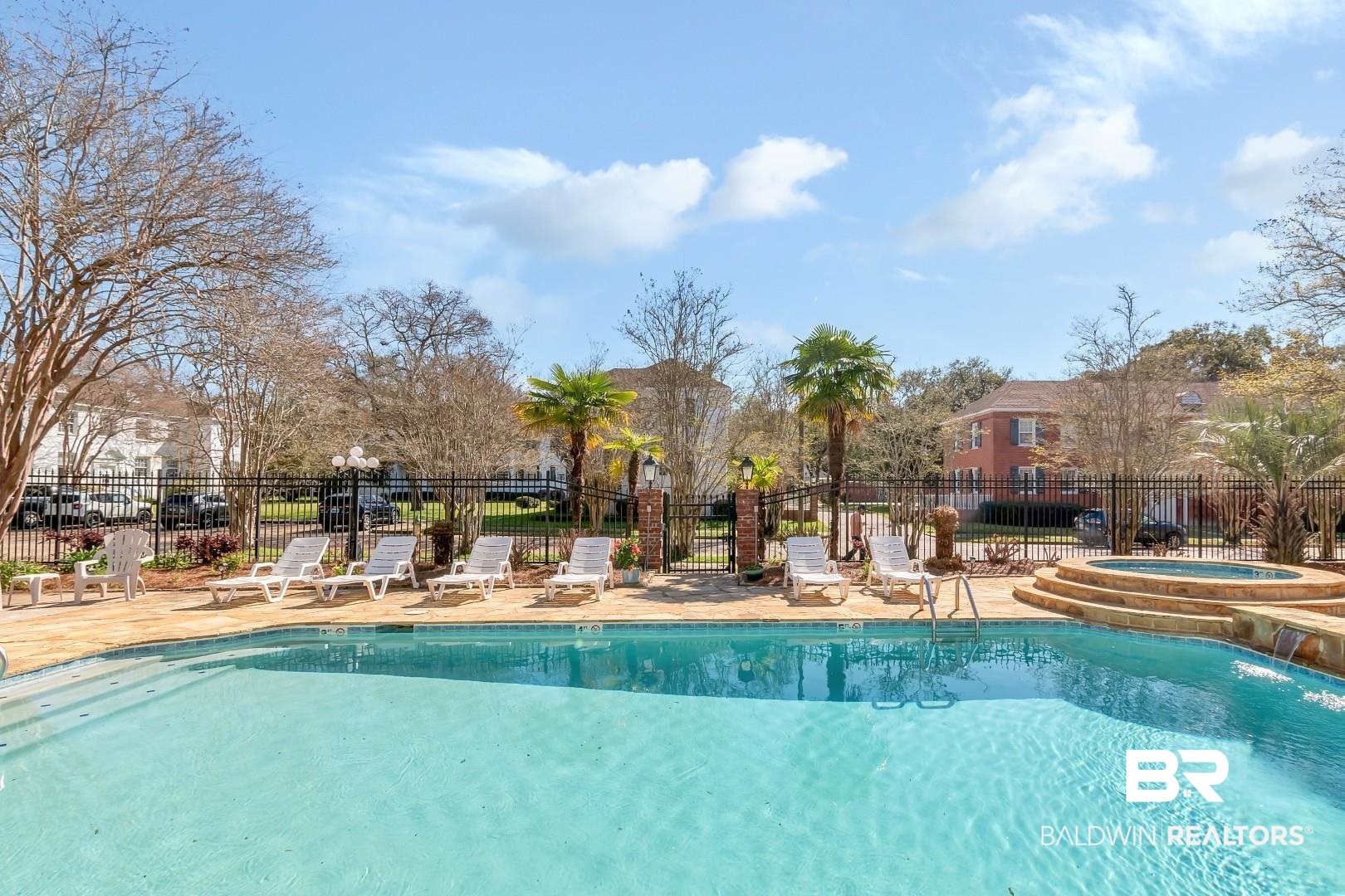 214 Upham Street, Unit 4A Mobile, AL 36607 - Photo 5 of 23 Community pool with a patio, a community hot tub, and fence