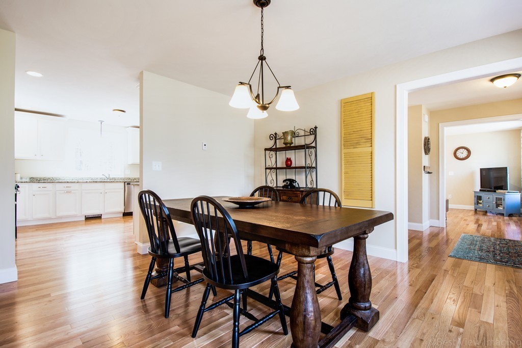 42 White Pond Road Stow, MA 01775 - Photo 11 of 26 a view of a dining room with furniture window and wooden floor