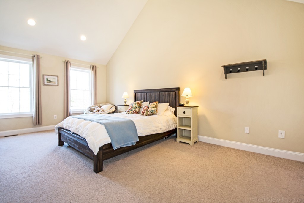 42 White Pond Road Stow, MA 01775 - Photo 15 of 26 a spacious bedroom with a bed and window