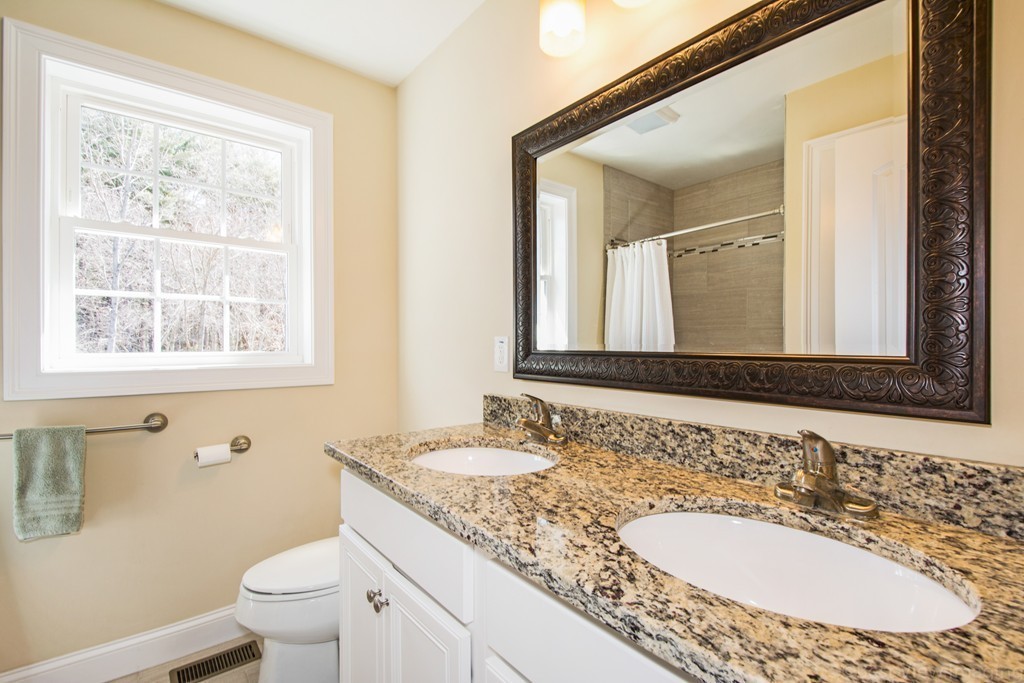 42 White Pond Road Stow, MA 01775 - Photo 17 of 26 a bathroom with a granite countertop sink a mirror and a toilet