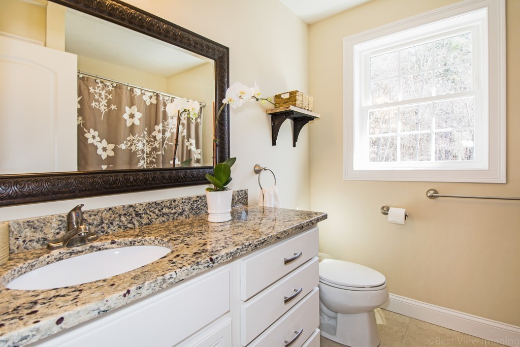 42 White Pond Road Stow, MA 01775 - Photo 21 of 26 a bathroom with a granite countertop sink and a mirror