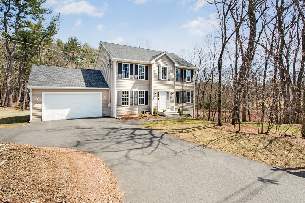 42 White Pond Road Stow, MA 01775 - Photo 26 of 26 a front view of a house with a yard and covered with snow