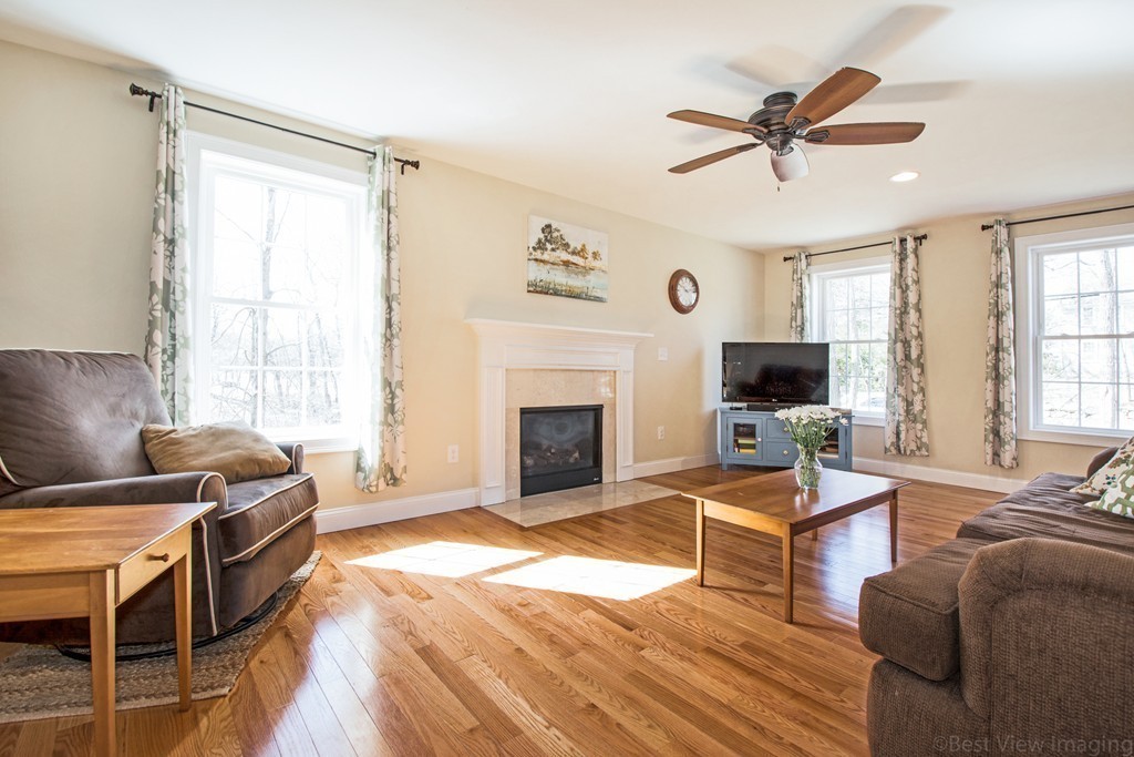 42 White Pond Road Stow, MA 01775 - Photo 3 of 26 a living room with furniture and a fireplace